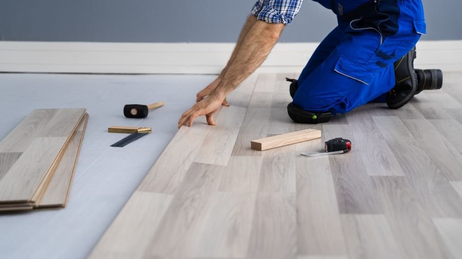 Installer fitting new wood flooring